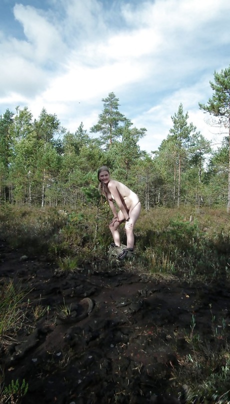 Outdoor posing with marvelous teen babe showing her ass in woods