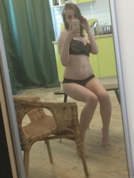 Dark-haired honey poses naked and in her sexy lingerie in the mirror