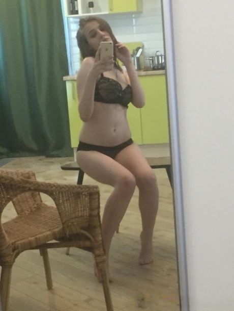 Dark-haired honey poses naked and in her sexy lingerie in the mirror