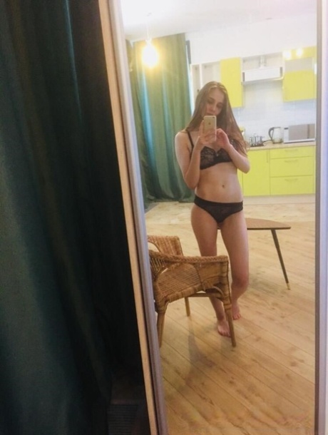 Dark-haired honey poses naked and in her sexy lingerie in the mirror