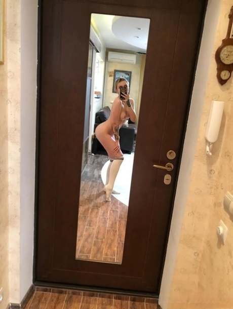 Sexy cheerleader takes nude selfies showing her small tits & her hot ass