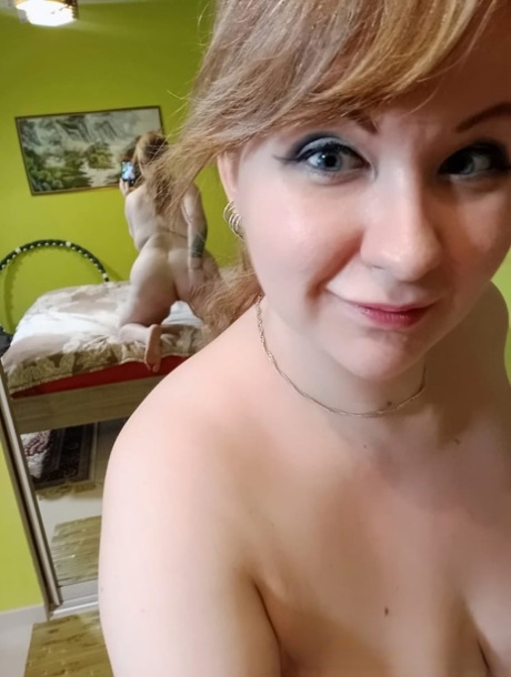 Petite MILF poses in the mirror and teases with her bubble ass and lovely tits