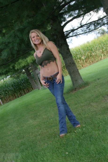 Hot MILF Madden removes her jeans in the backyard to tease in thong panties