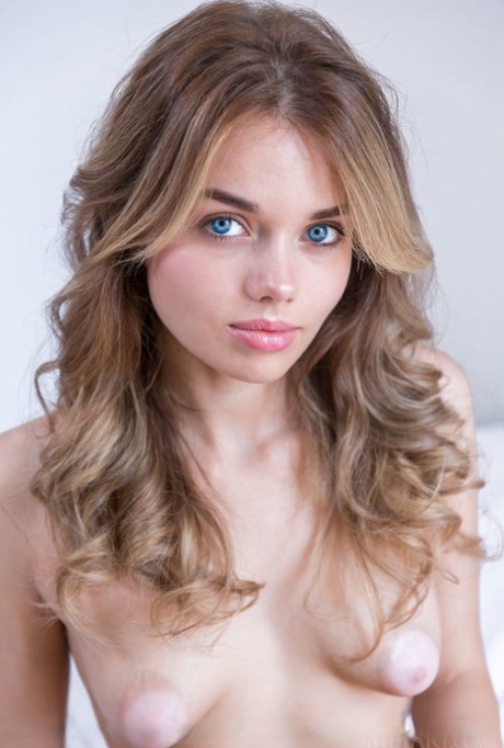 Young teen Keira Blue uncovers tiny tits as she gets naked on her bed