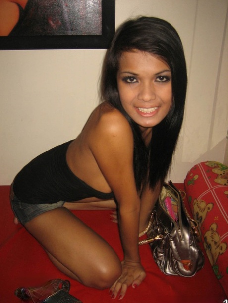 Attractive Asian shemale Dada squeezing her incredible breasts at home