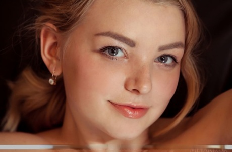 Busty young Daniel Sea puts her legs in the air to reveal her spread femininity