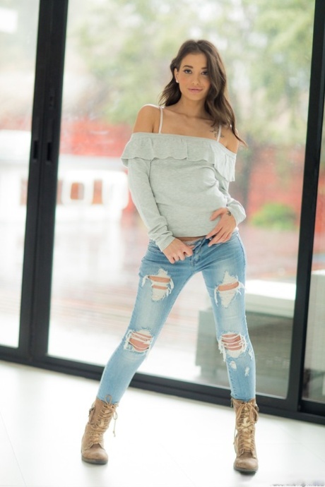 Brunette American babe Gia Paige strips and exposes her alluring white panties